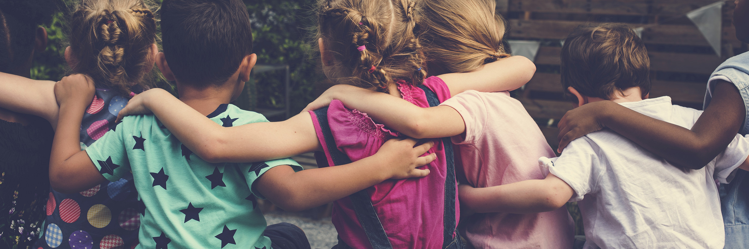 Photo of children with linked arms