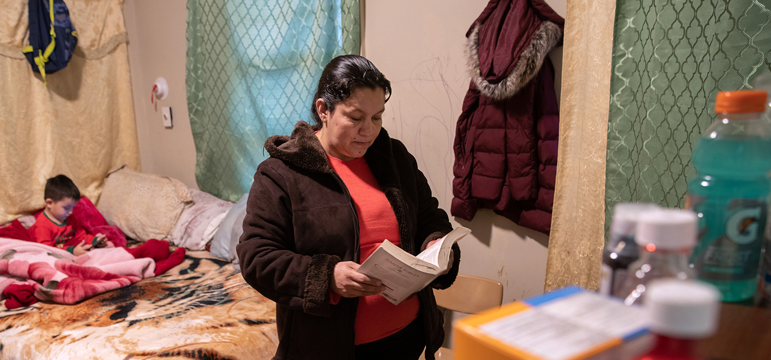 An undocumented Honduran immigrant reads her Bible during self-quarantine with her family for possible COVID-19 on March 30, 2020 in Mineola, New York. 