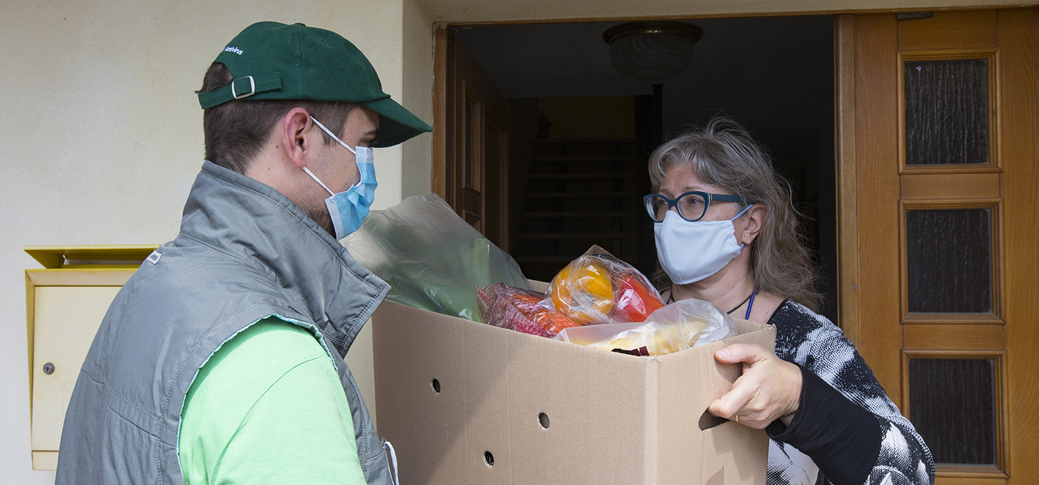 Woman accepts a box of produce