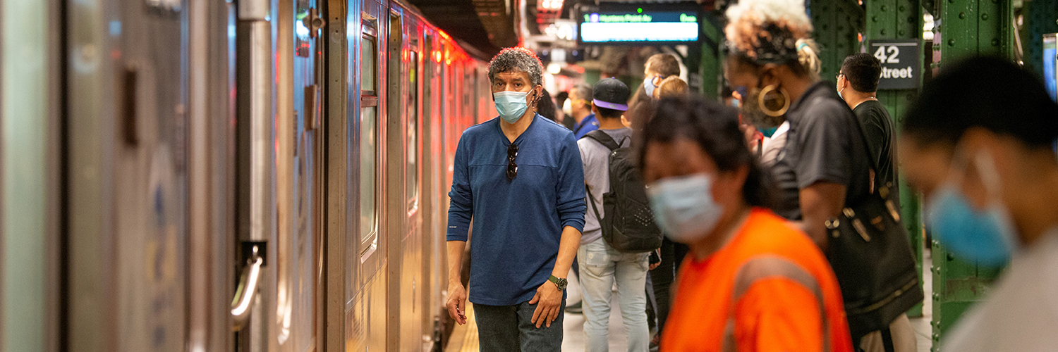 People wearing mask wait on a crowded subway platform on May 30, 2020 in New York City.