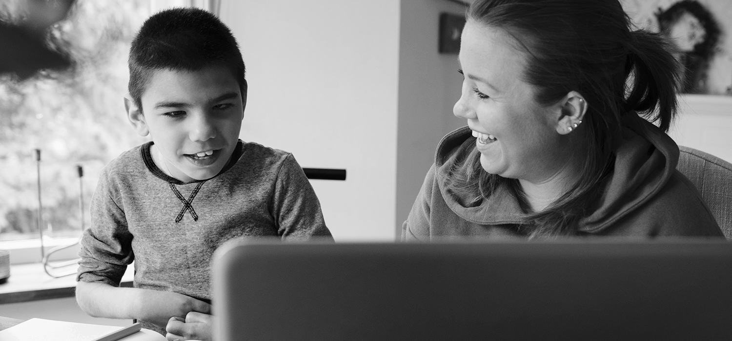 Parent tutors their young child with a disability