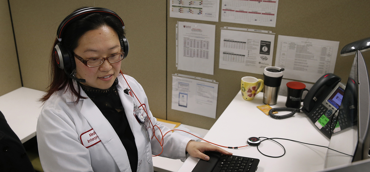 Interpreter speaks with patients from a health care call center