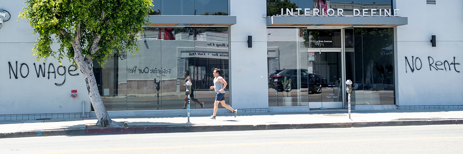 Graffiti wall says "No Wage No Rent"