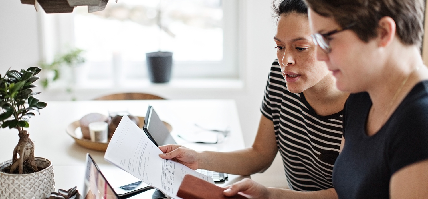 Two people review paperwork together