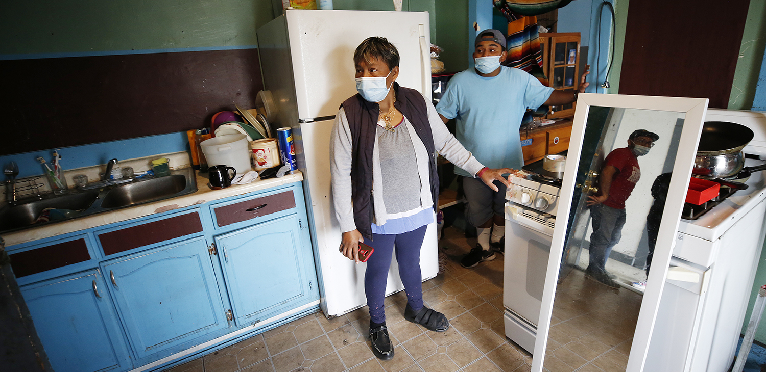 Maria Martinez with her son Ricardo Martinez, right, talk to Roberto Garcia-Ceballos, reflected in the doorway, at the Tokio Hotel on Monday, Oct. 4, 2021. 