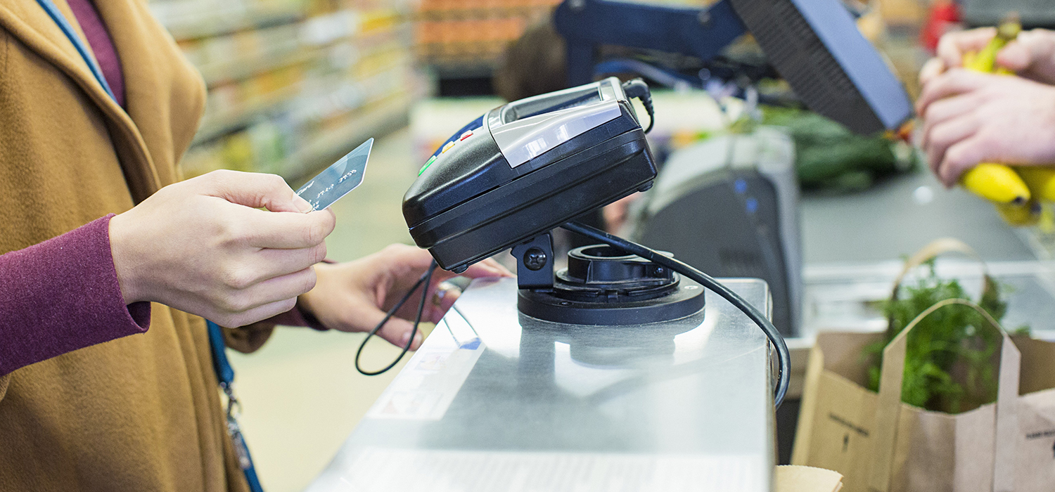 Women paying at grocery store