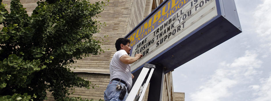 Man changing school sign