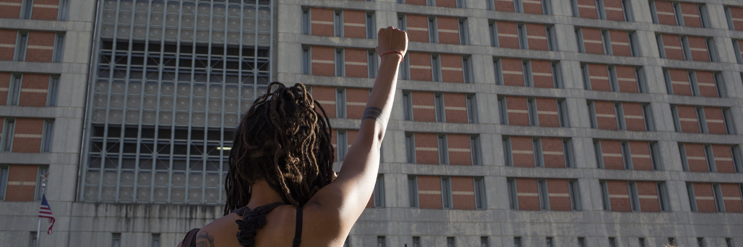 Women with hand up in protest 