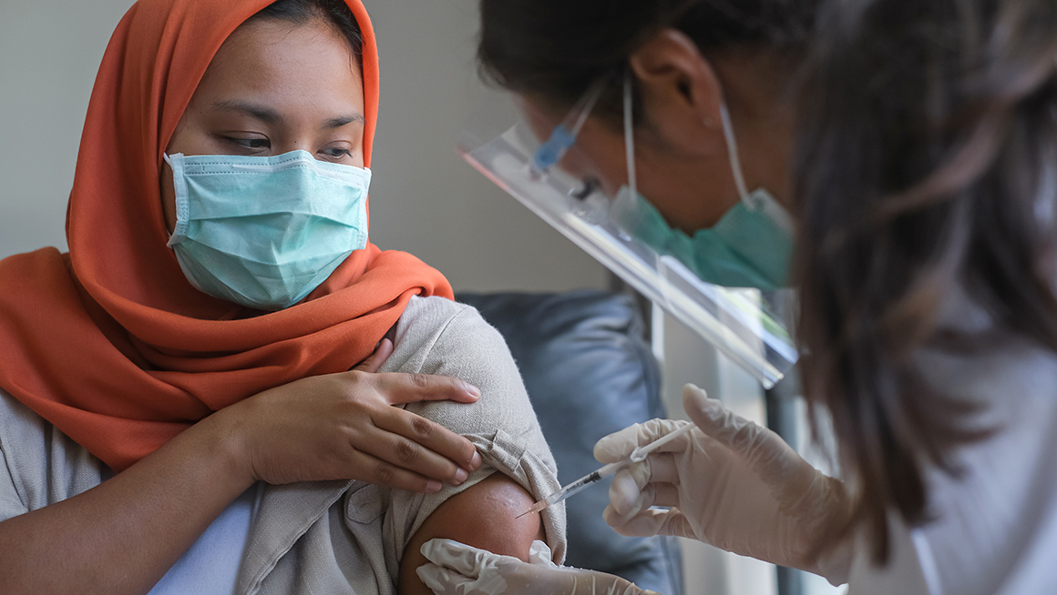 Woman getting a vaccine. 