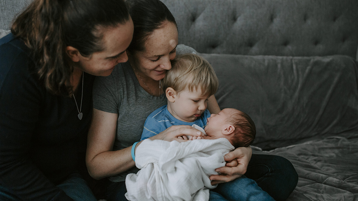 parents holding their children