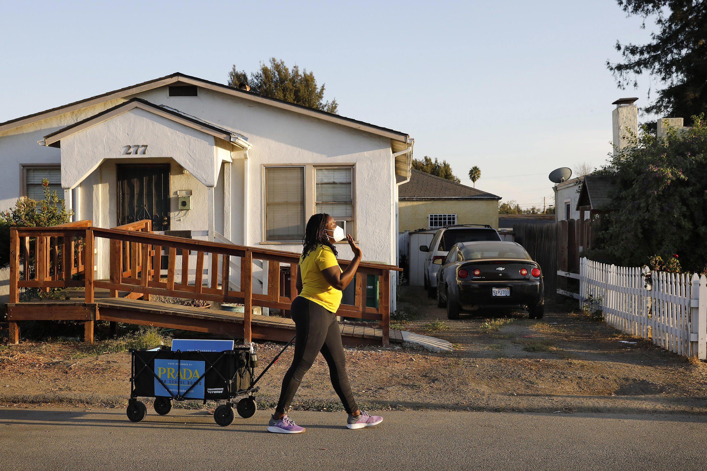 Sara Prada wheels materials for her school board run through her neighborhood as she campaigns ahead of the November 2020 election.