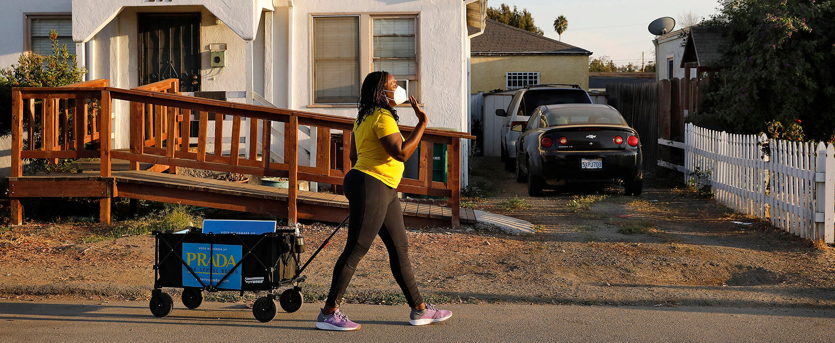 Sara Prada wheels materials for her school board run through her neighborhood as she campaigns ahead of the November 2020 election.