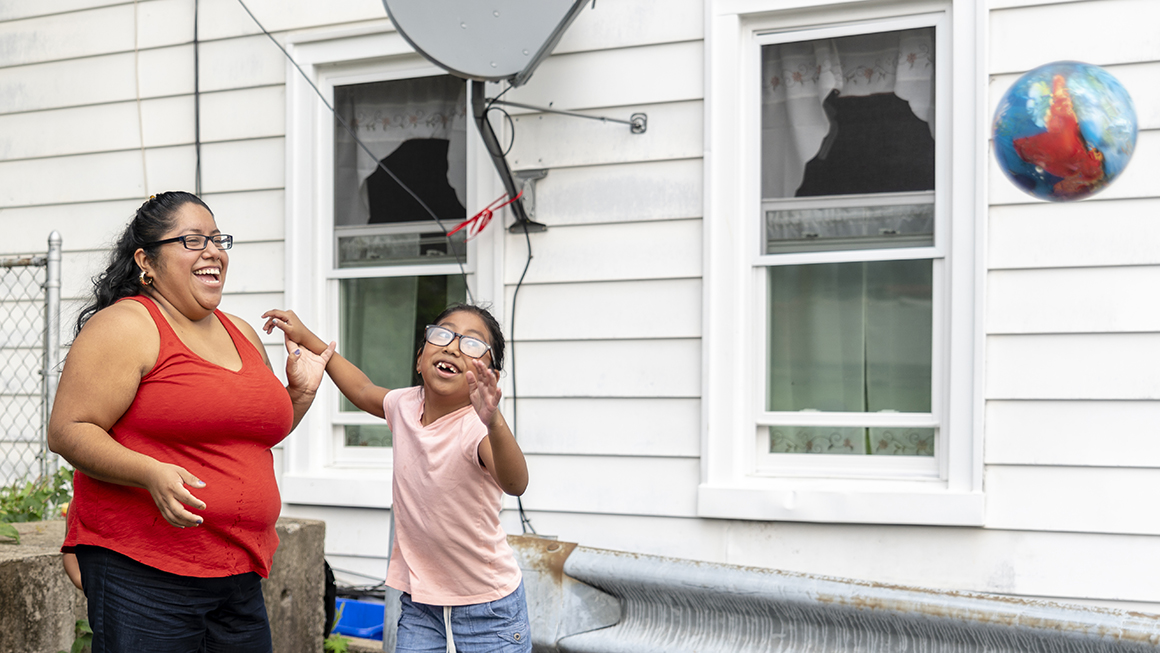 A parent and child play outside