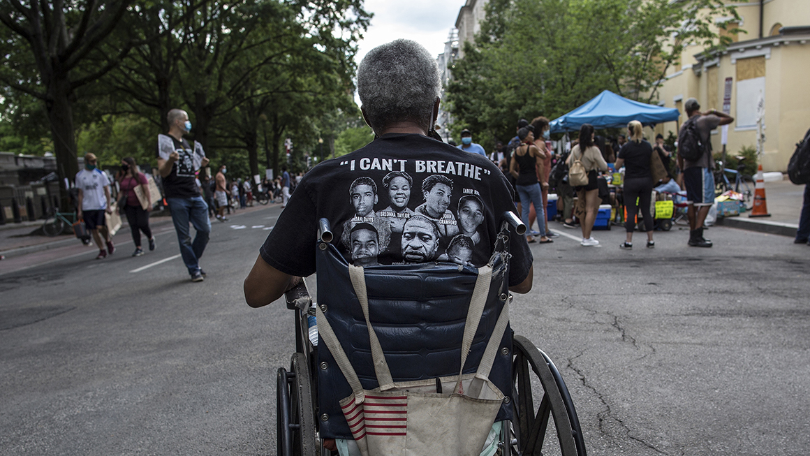 A wheelchair-bound man wearing a t-shirt with I can't breathe written on it, takes part in a demonstration near the White House while protesting against police brutality and racism.
