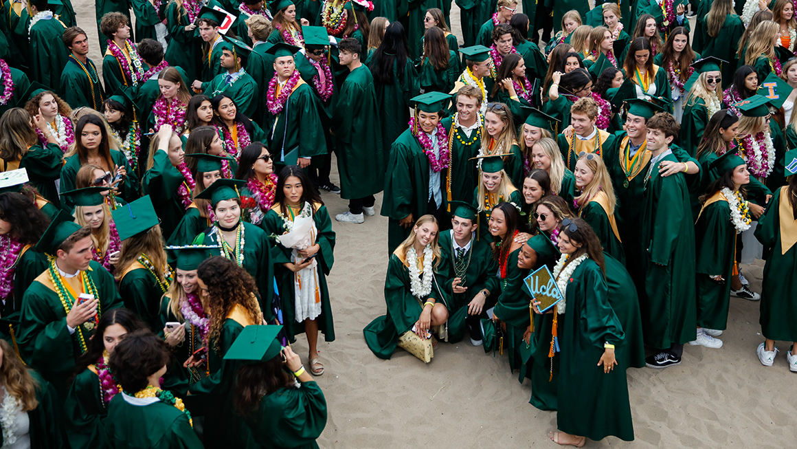 High School graduates pose for pictures next to the Manhattan Beach Pier