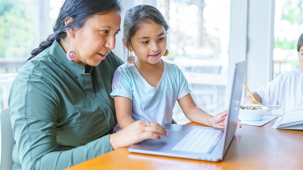 Woman and daughter looking at a laptop