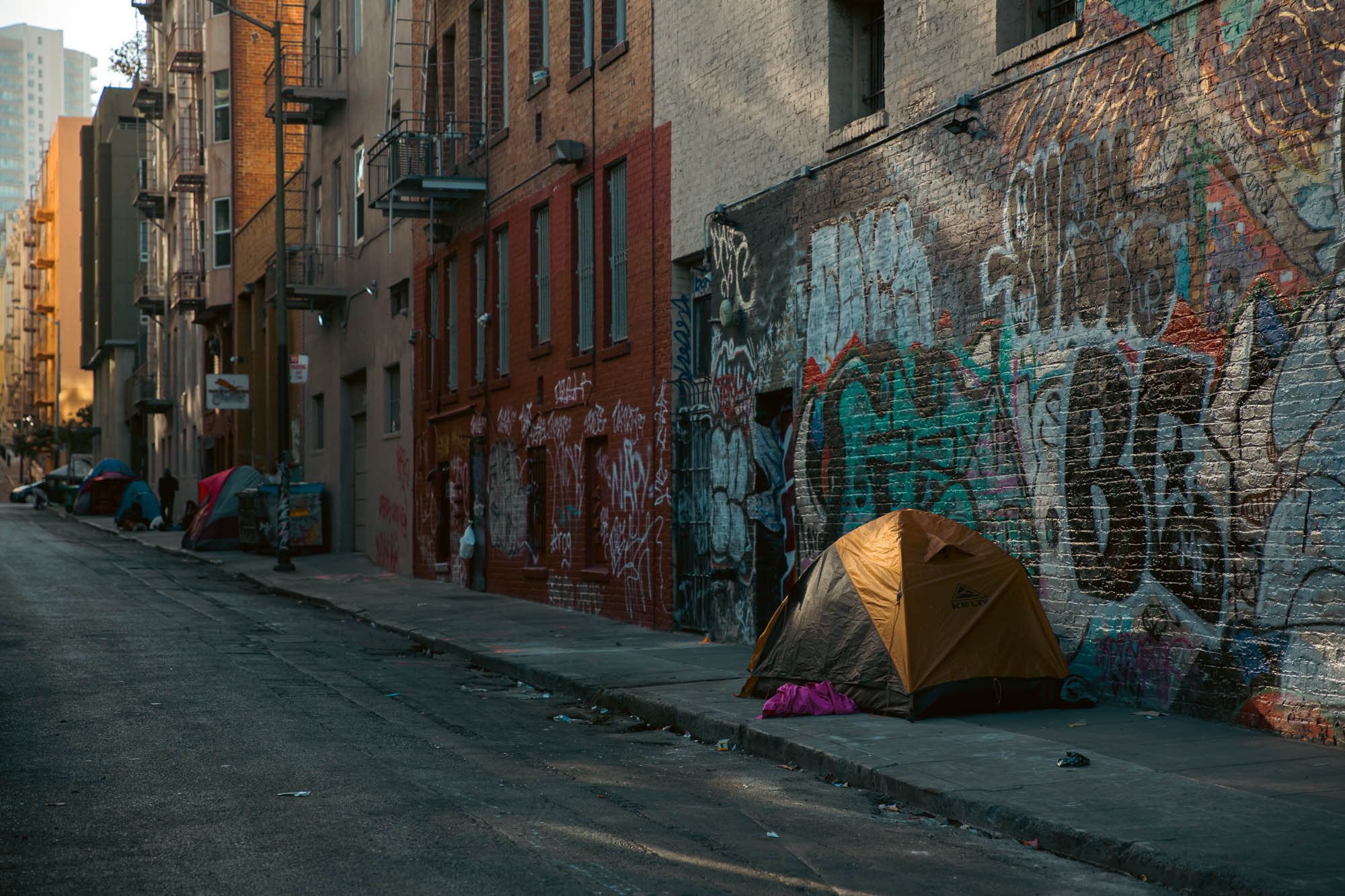 Several tents line an alley in the Tenderloin, a San Francisco neighborhood where many people experiencing homelessness live.