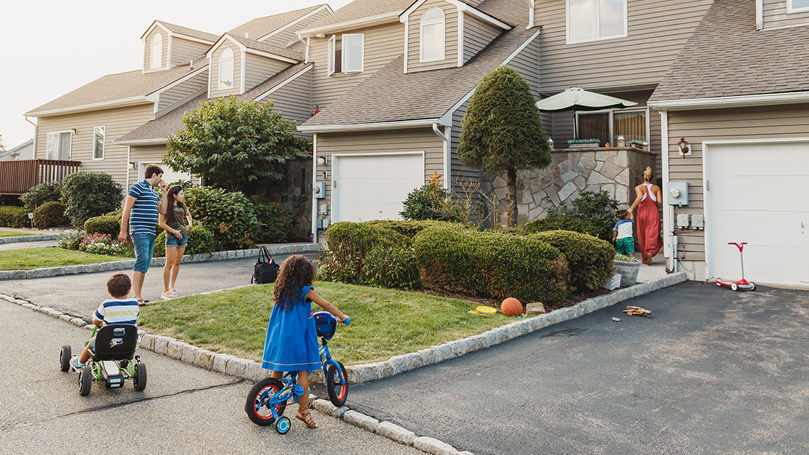 Young family outside a house.