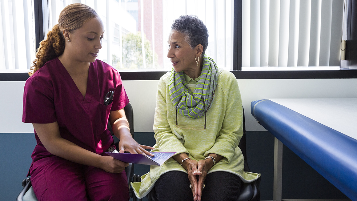Health care worker talking with a patient