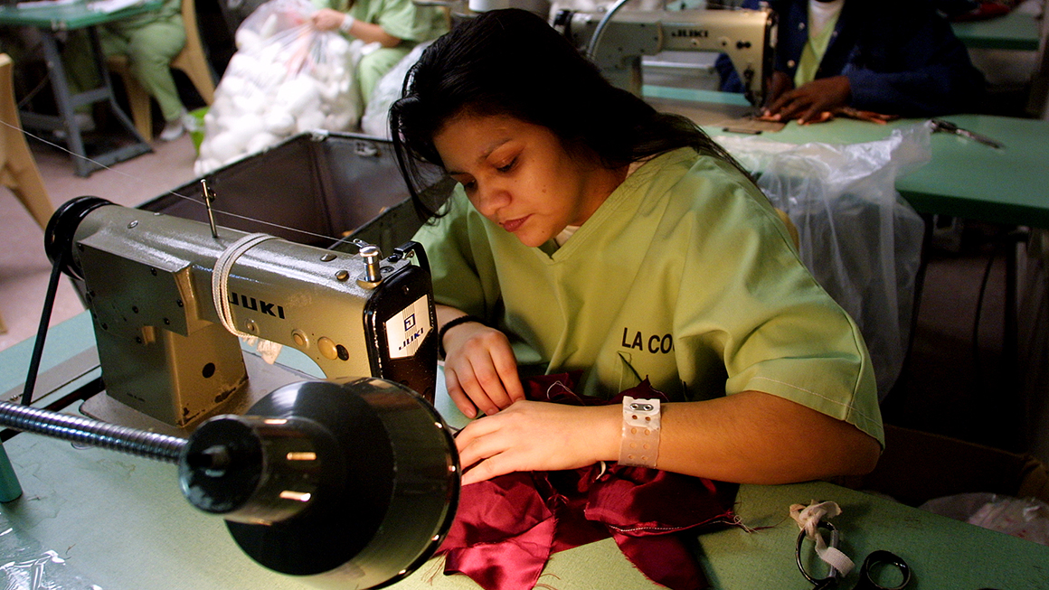 nmate Priscilla Sandoval, 26, sews doll clothing for dolls that will be distrbuted to needy children for Christmas at Twin Towers jail.