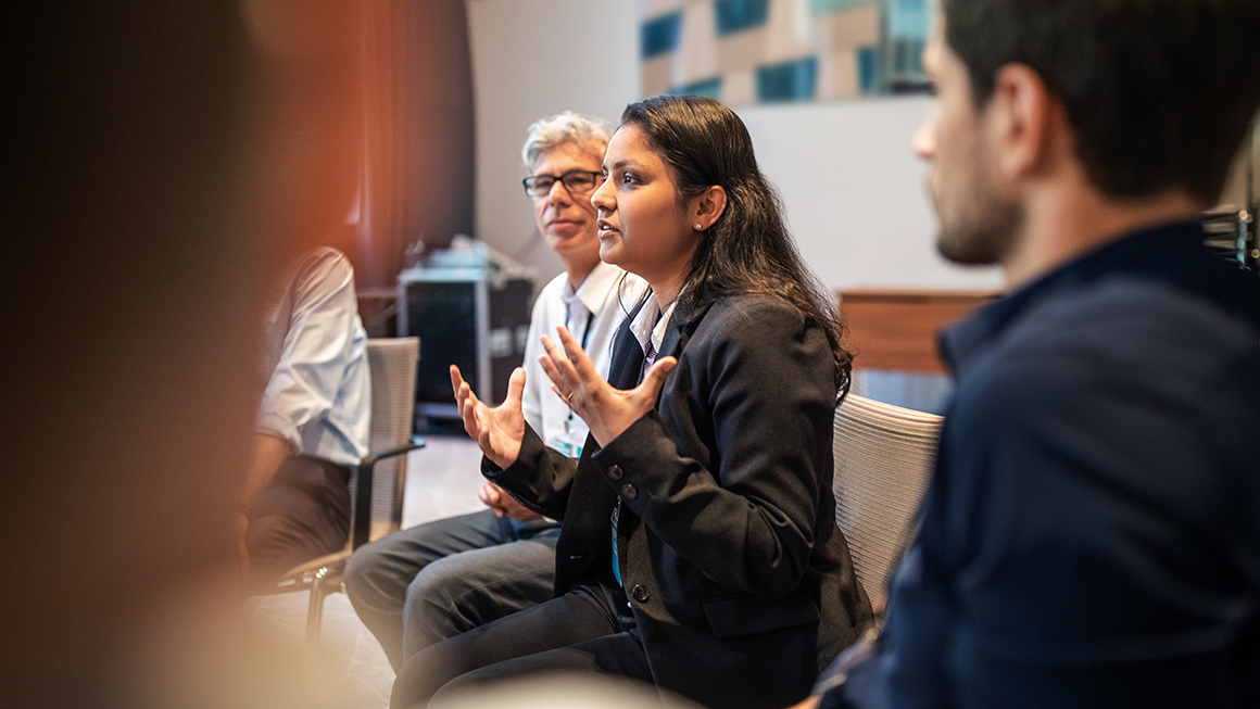 Woman speaking among a group of people