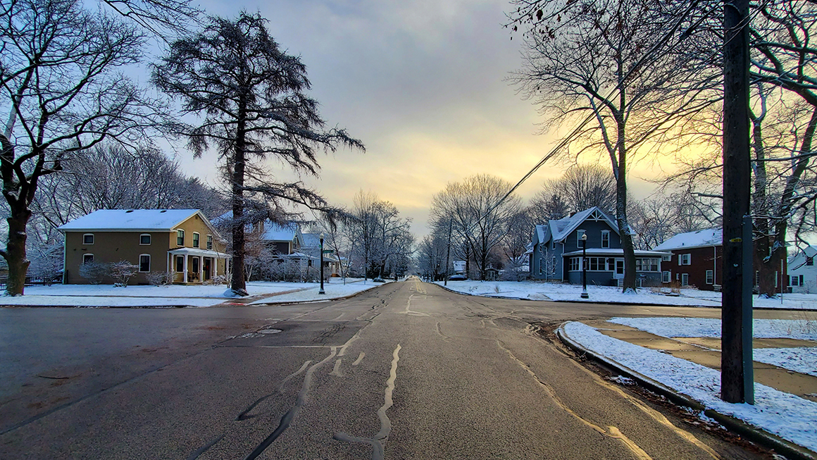 A photo of snowy residential street. 