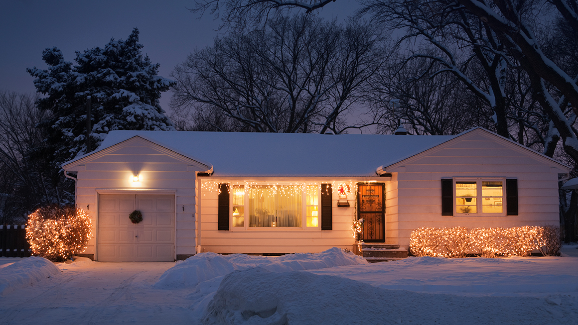 an Image of a house with snow surrounding. 