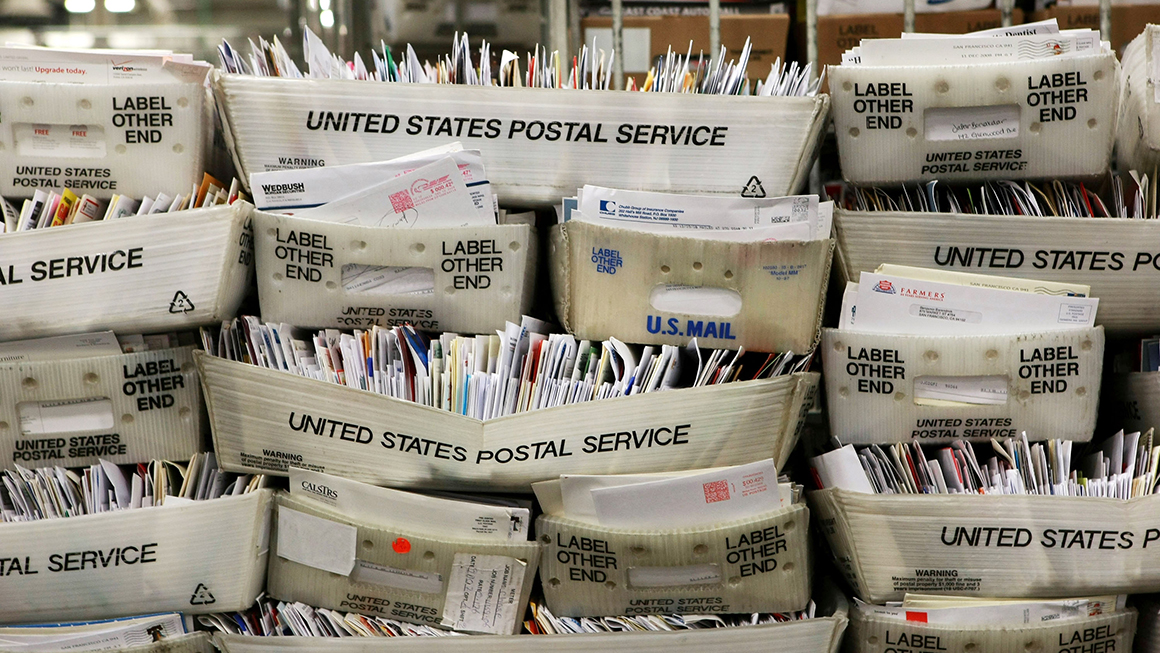 stacks of us postal mail. 