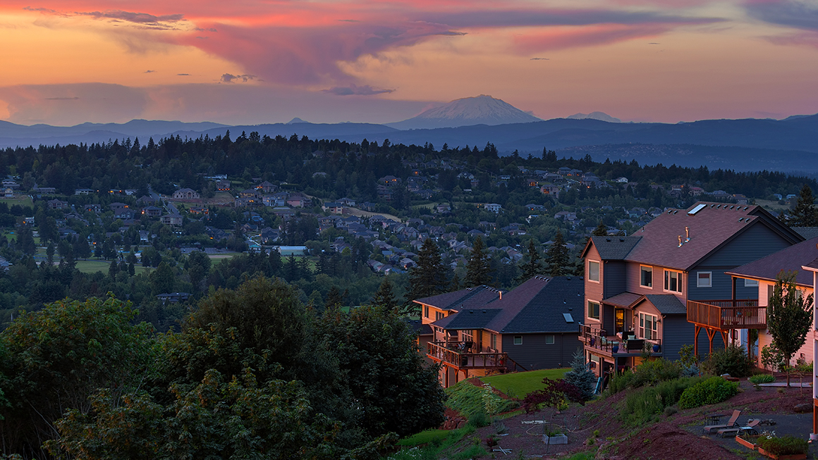 A wide shot of a neighborhood at sunset. 