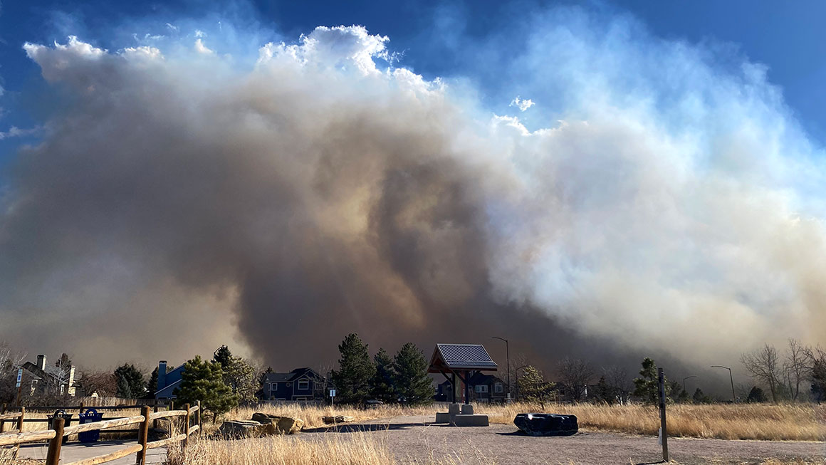 Smoke from the Marshall Fire in Louisville, CO can be see in a large smoke plume as it covers the horizon
