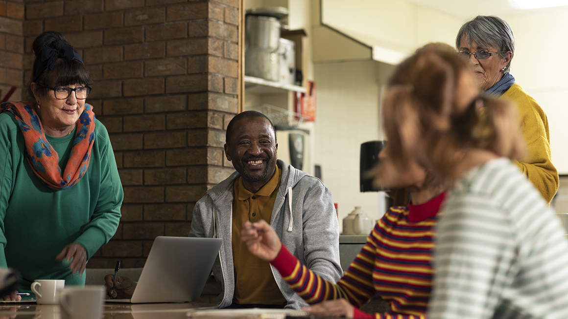 A group of people sitting around a table. 