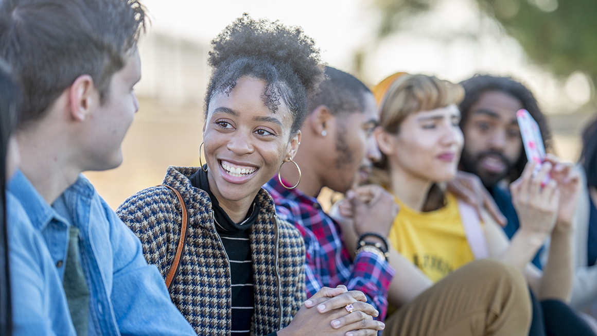 A group of young adults spending time together outside. 