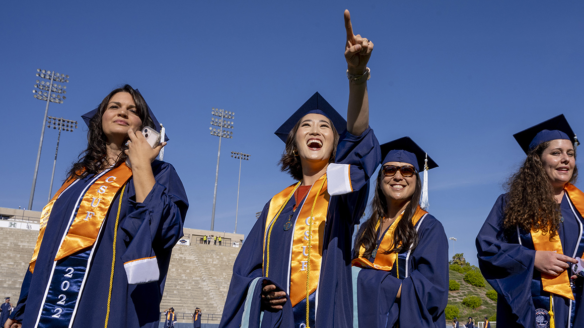 A group of college graduates in their cap and gowns.