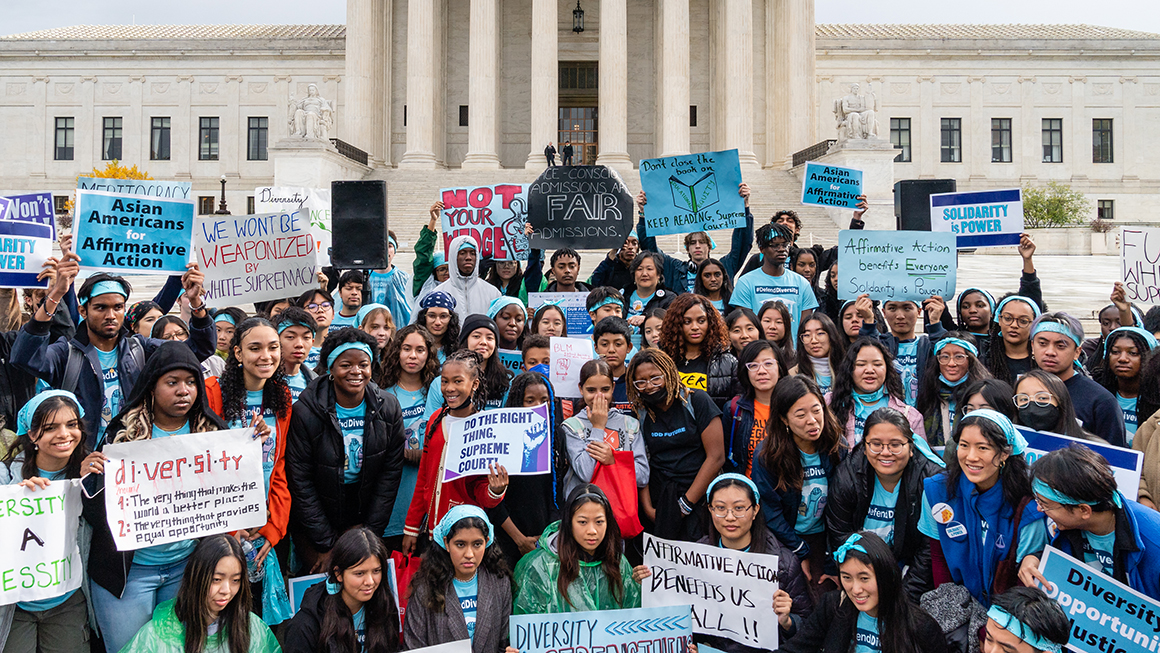 Supporters pose for a group photo during a rally in support affirmative action policies outside the Supreme Court