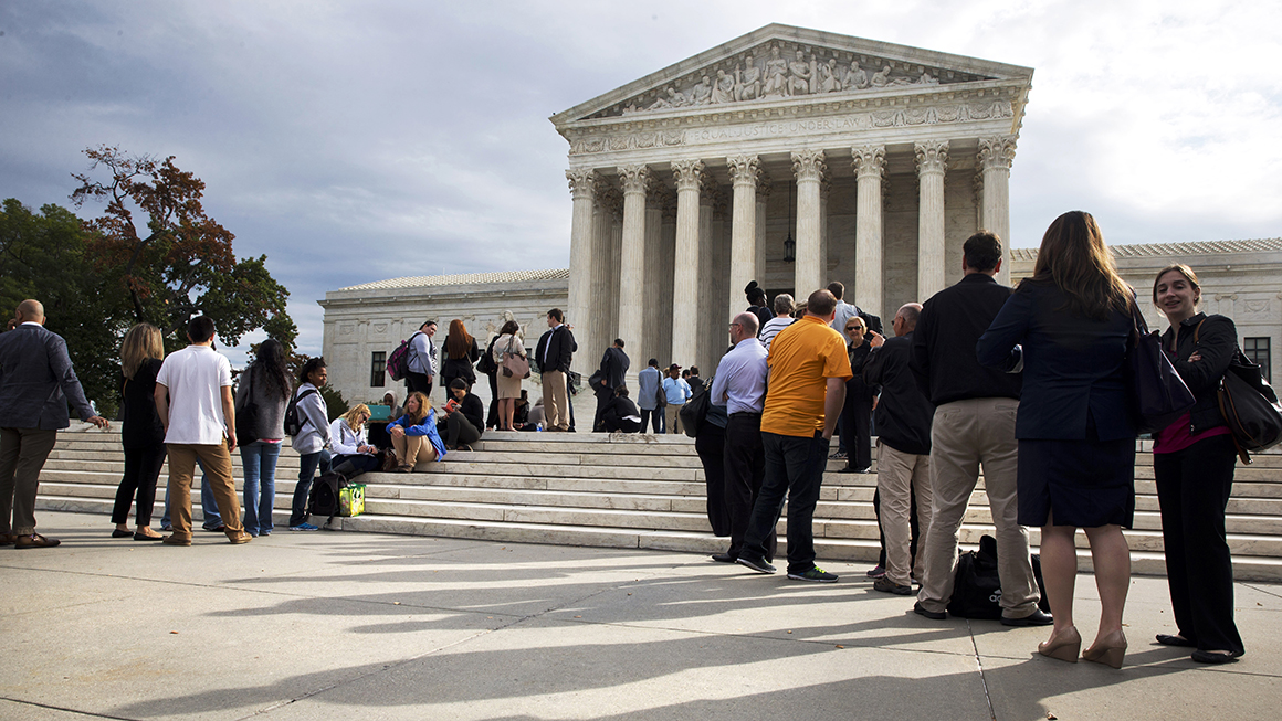 People line up outside of the Supreme Court in Washington.