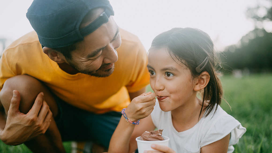 A father and daughter eating ice cream.