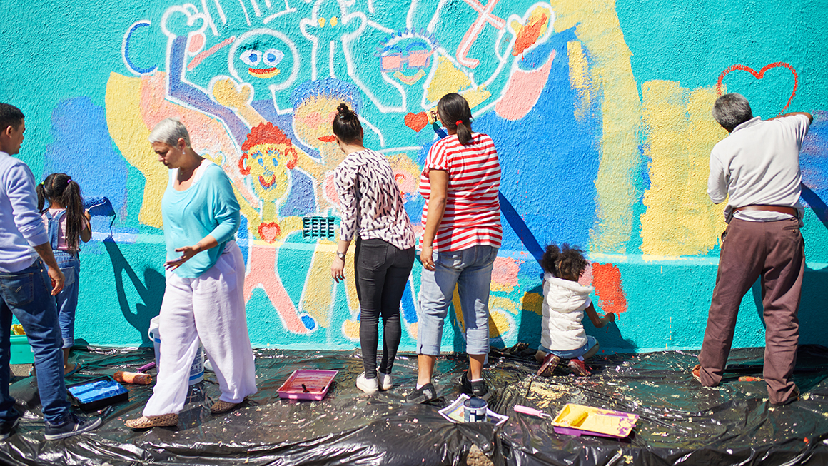 People painting a mural together.