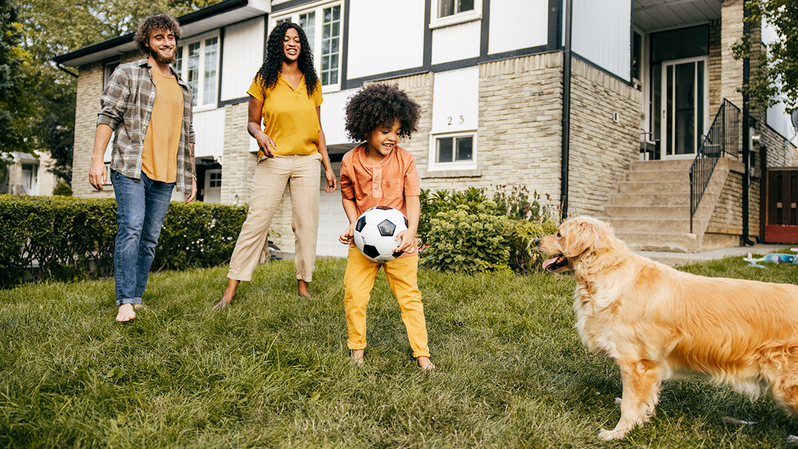 A family playing outside on their lawn.