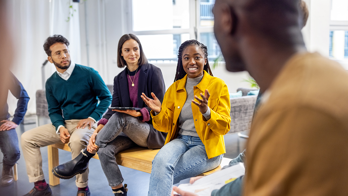 A group of people talking to each other.