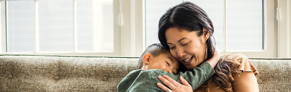 photo of mother hugging son