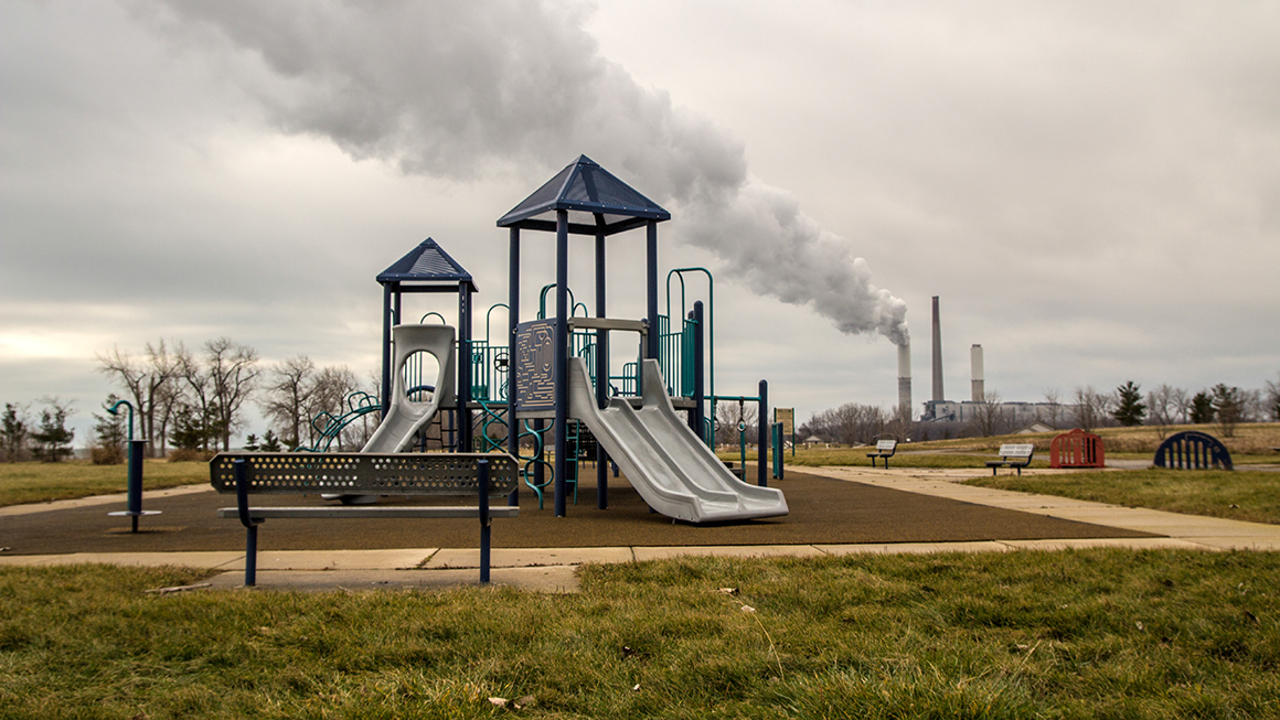 A playground near a factory. 