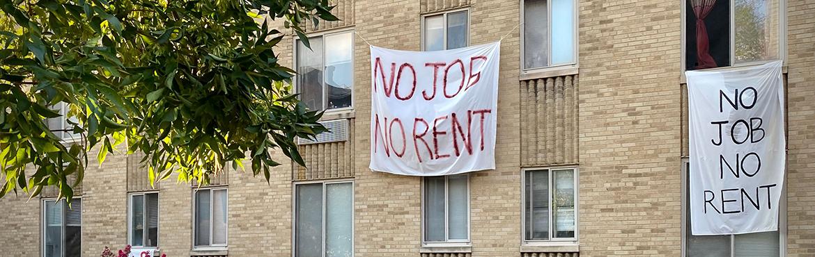 Banners against renters eviction reading "no job, no rent" are displayed on a controlled rent building in Washington, DC
