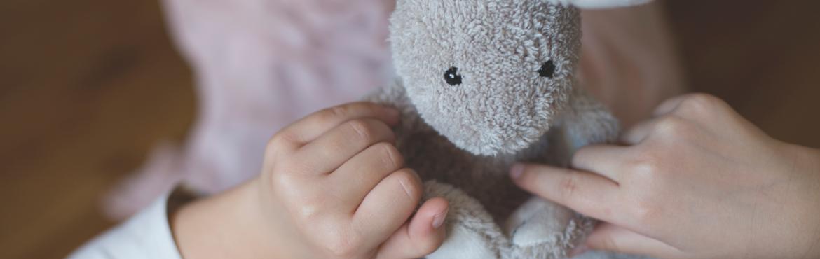 Girl playing with a small rabbit