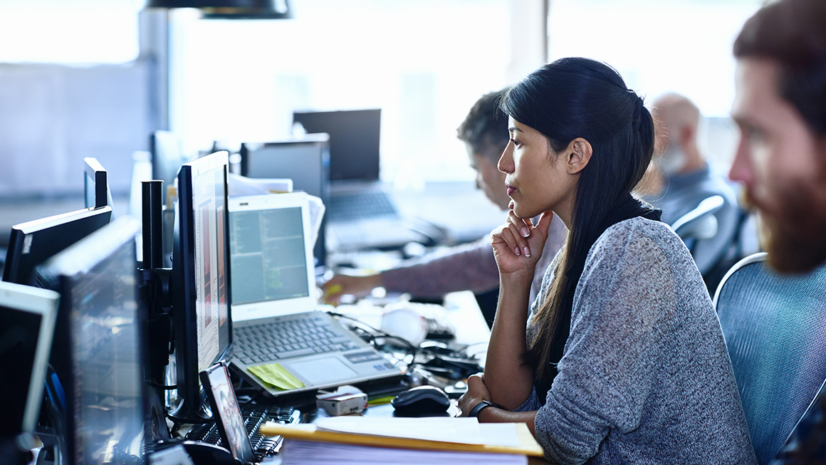 A woman looking at a computer screen.