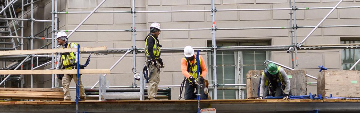 Construction workers put up scaffolding in Washington, DC on October 8, 2019