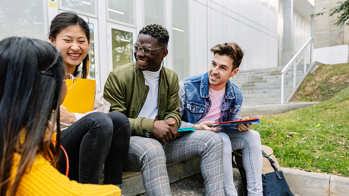 A group of college students talking outside.