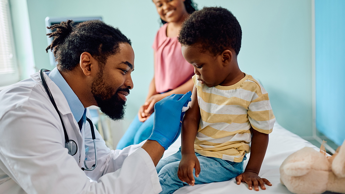 photo of doctor giving vaccine to child