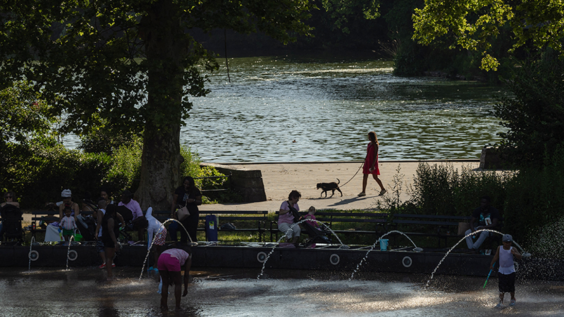 People run across a splash pad at LeFrak Center at Lakeside at Prospect Park in Brooklyn, New York, as a heat wave hits the northeast US on June 20, 2024.