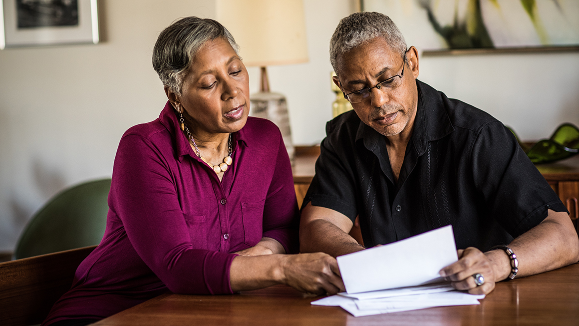 photo of senior couple paying bills at home