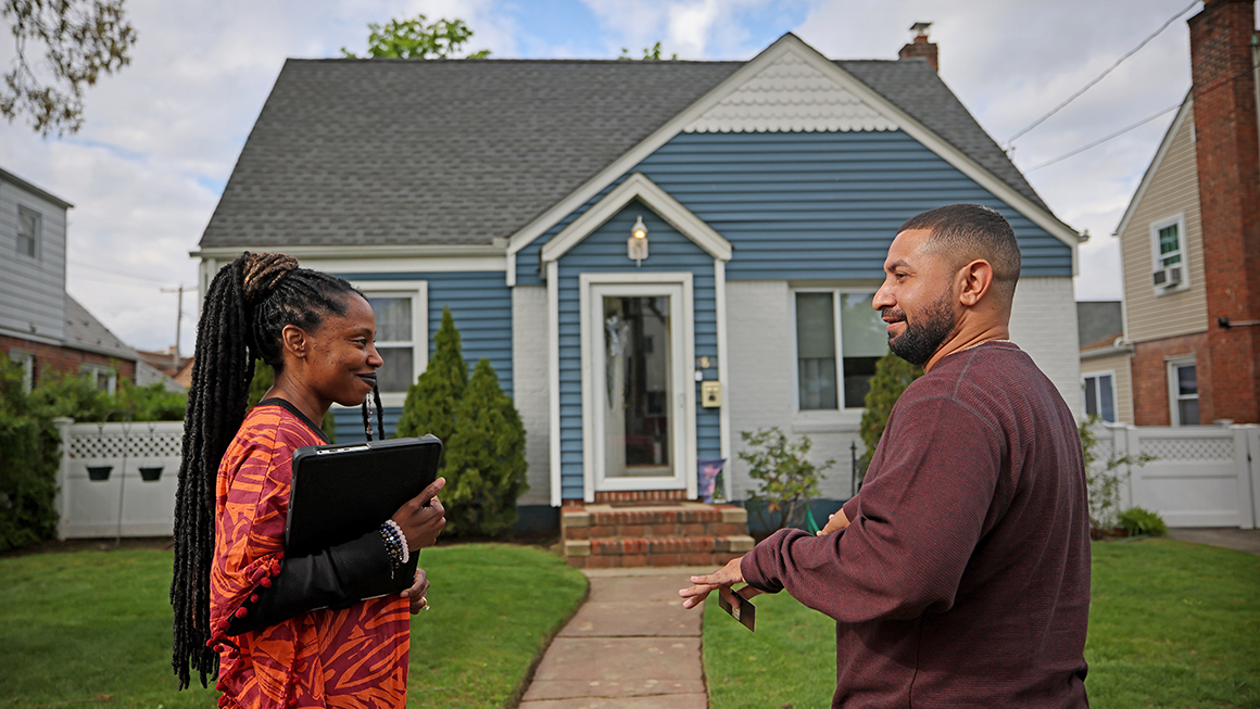 photo of people talking in front of a house